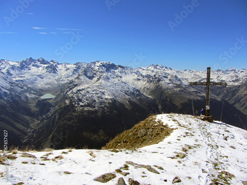 Versalspitze mit Gipfelkreuz im Montafon Gebirge mit Blick auf den Silvretta Stausee photo