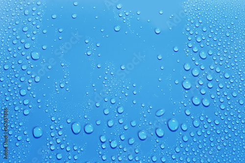 Water drops on smooth surface, blue background