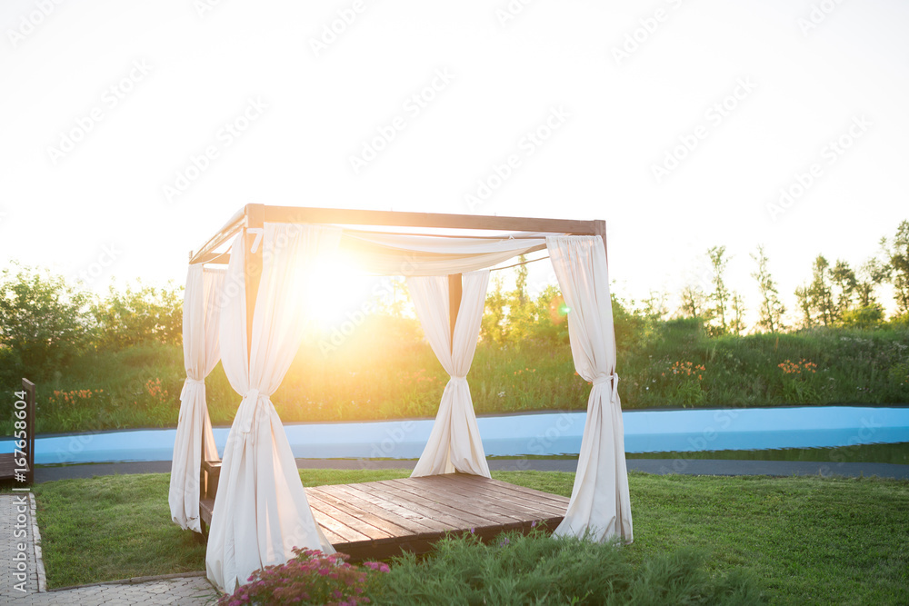 Area for rest alongside a highway under a canopy, park resting-place. A sunset day for a break in the journey by the roadside. Area for rest alongside a highway under a canopy, park resting-place. A sunset day for a break in the journey by the roadside.