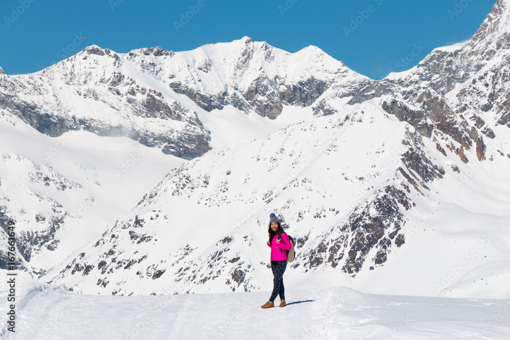 an asian young woman traveling on the snow mountain