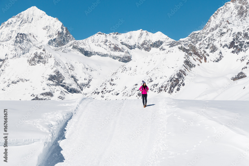 an asian young woman traveling on the snow mountain