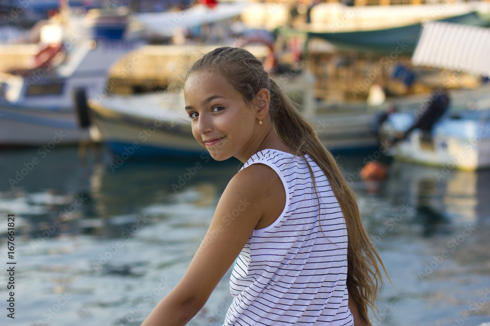 Pretty young girl near the Mediterranean sea looking forward . Antalya, Turkey, marina