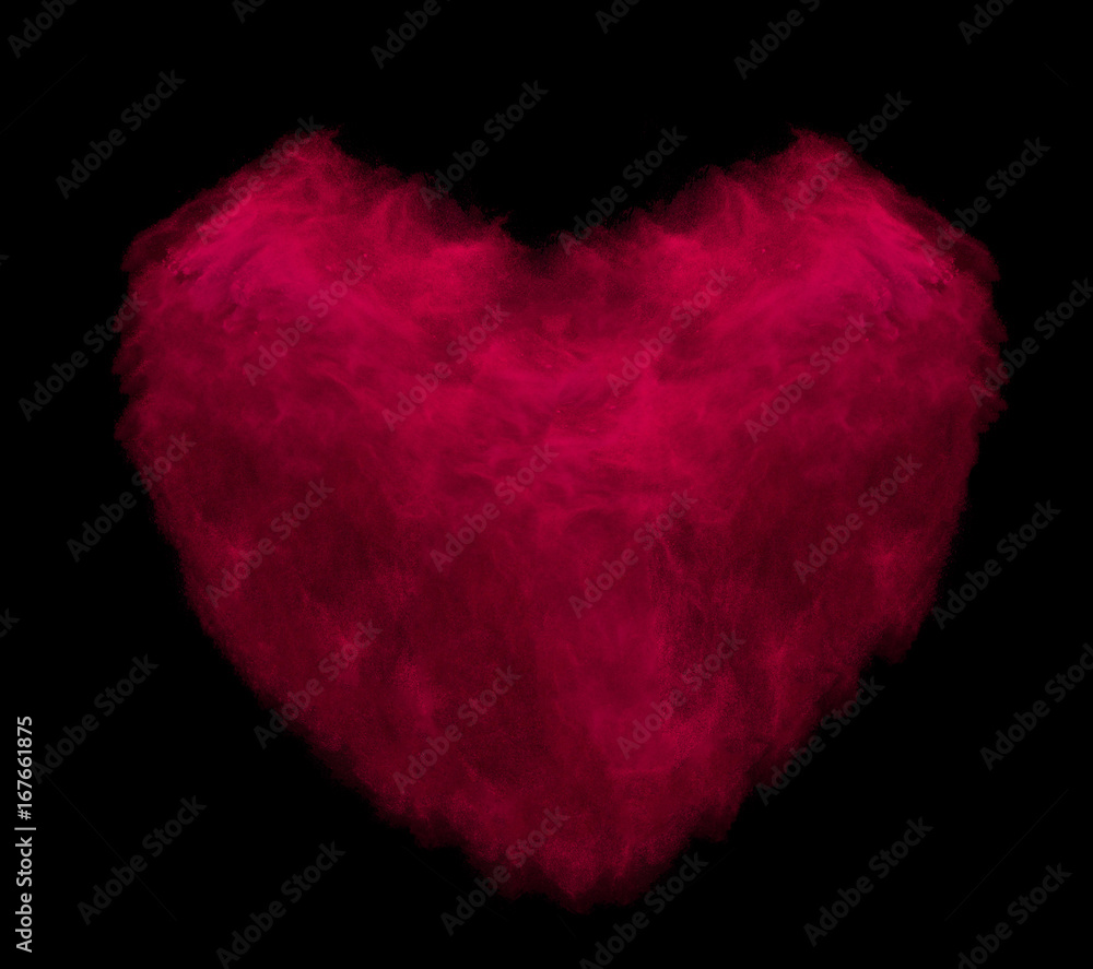 Red heart made of powder explosion isolated on black background