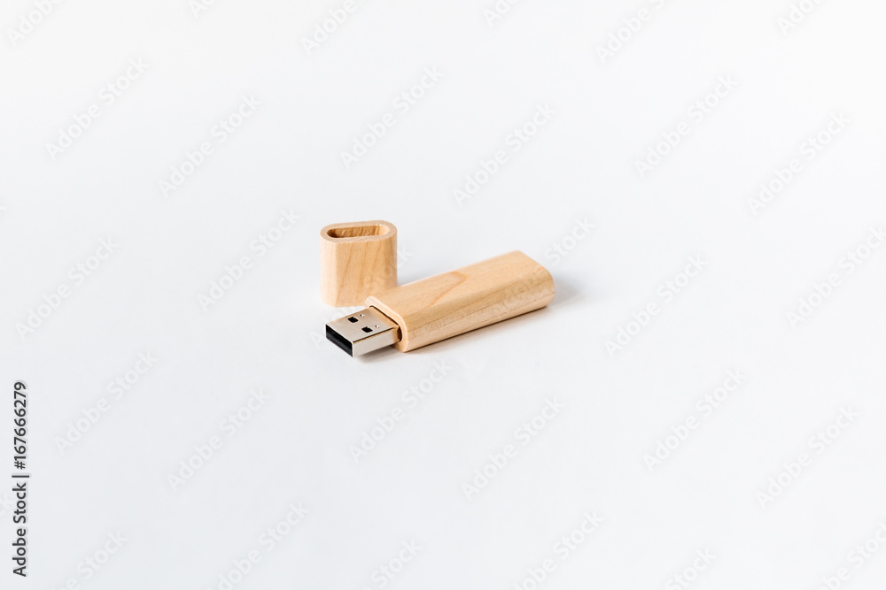 Light Wooden USB flash drive on a white isolated background. Copy space. Light Wooden USB flash drive on a white isolated background. Copy space.