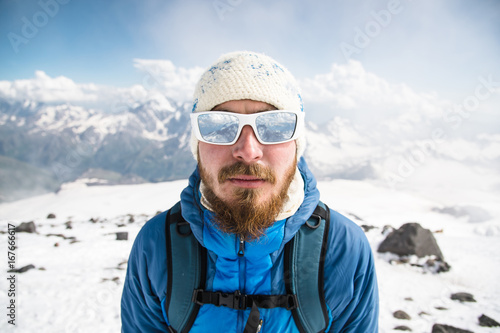 Portrait of a bearded guide wearing a hat and sunglasses