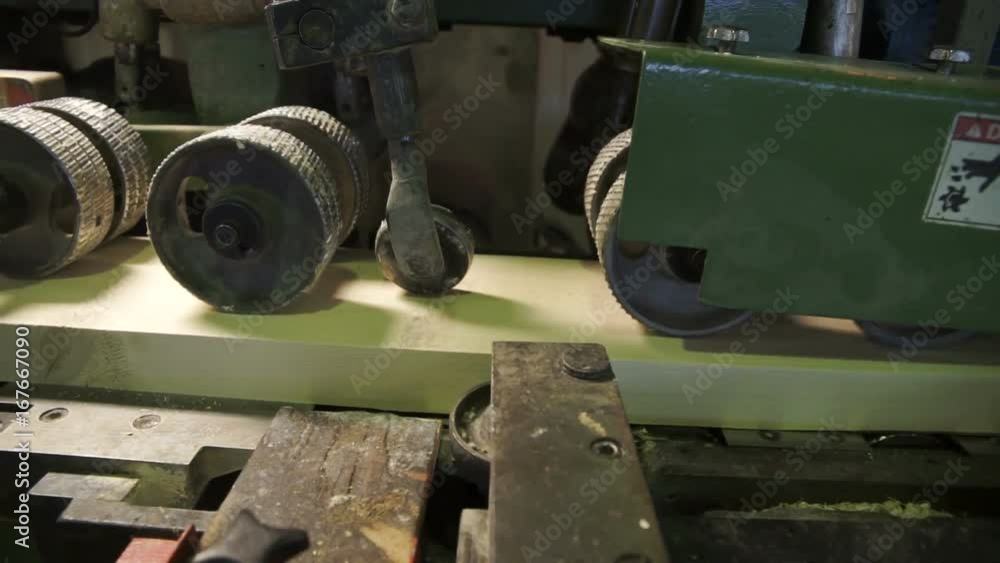 Wood being transported in a conveyor belt in a wood processing factory Wood being transported in a conveyor belt in a wood processing factory