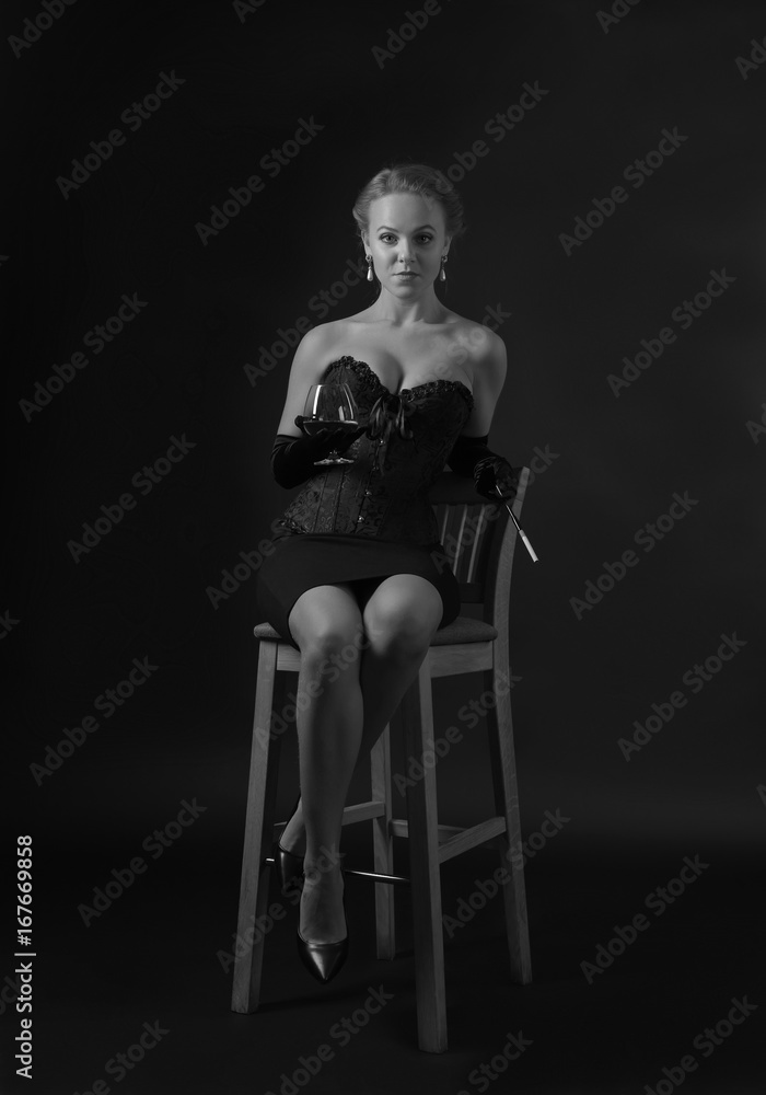 Fototapeta premium Young beautiful woman with glass of brandy.