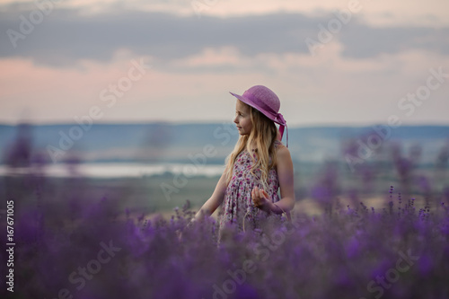 Beautiful girl in a field of lavender on sunset. Beautiful girl in amazing dress walk on the field of lavender. © Inna Darda