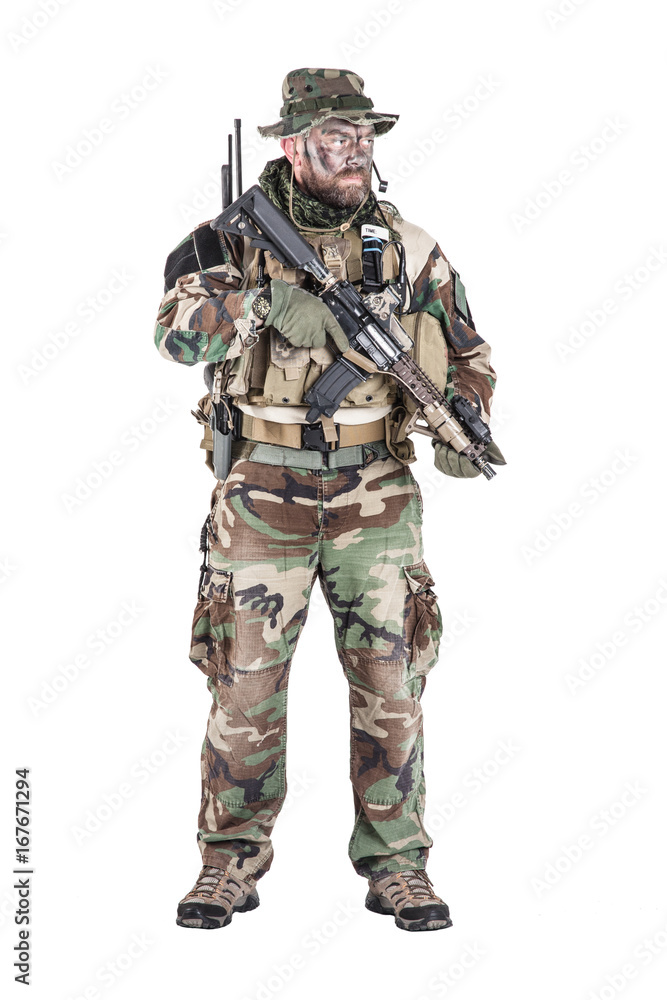 Special forces United States in Camouflage Uniforms studio shot. Holding weapons, wearing jungle hat, Shemagh scarf, painted face, his outfit clothes designed for jungle warfare. Studio shot isolated Special forces United States in Camouflage Uniforms studio shot. Holding weapons, wearing jungle hat, Shemagh scarf, painted face, his outfit clothes designed for jungle warfare. Studio shot isolated