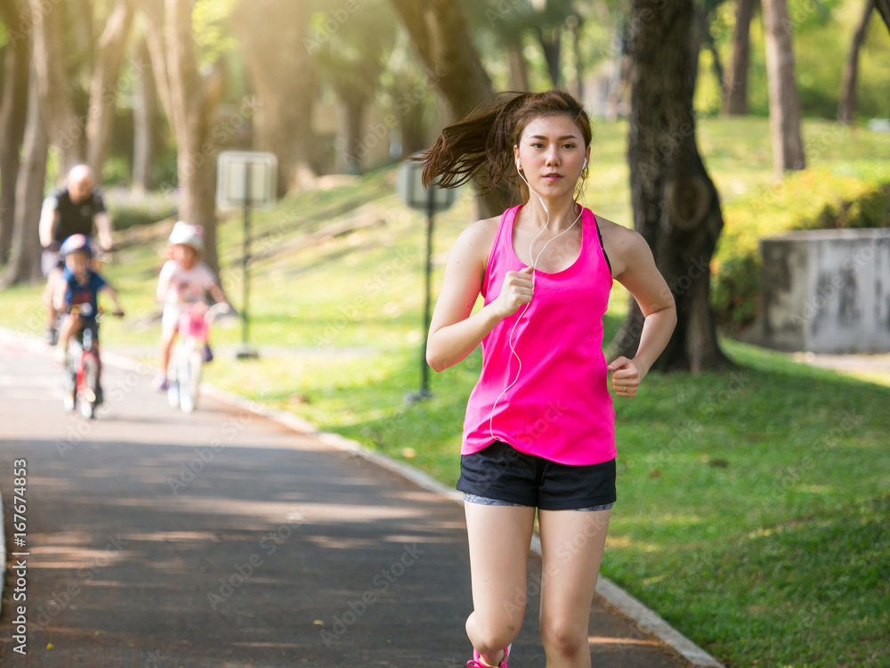 Woman fitness outdoor concept, young asian beautiful woman/sport girl running walking at outdoor park with fresh, relax, happy feeling. Woman fitness outdoor concept, young asian beautiful woman/sport girl running walking at outdoor park with fresh, relax, happy feeling.