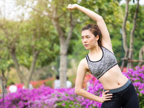 Woman fitness outdoor concept, young woman stretching for sport workout, yoga, running at park in the morning, fresh, relax and happy feeling © Nattakorn