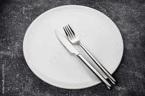 Fork and knife on white plate