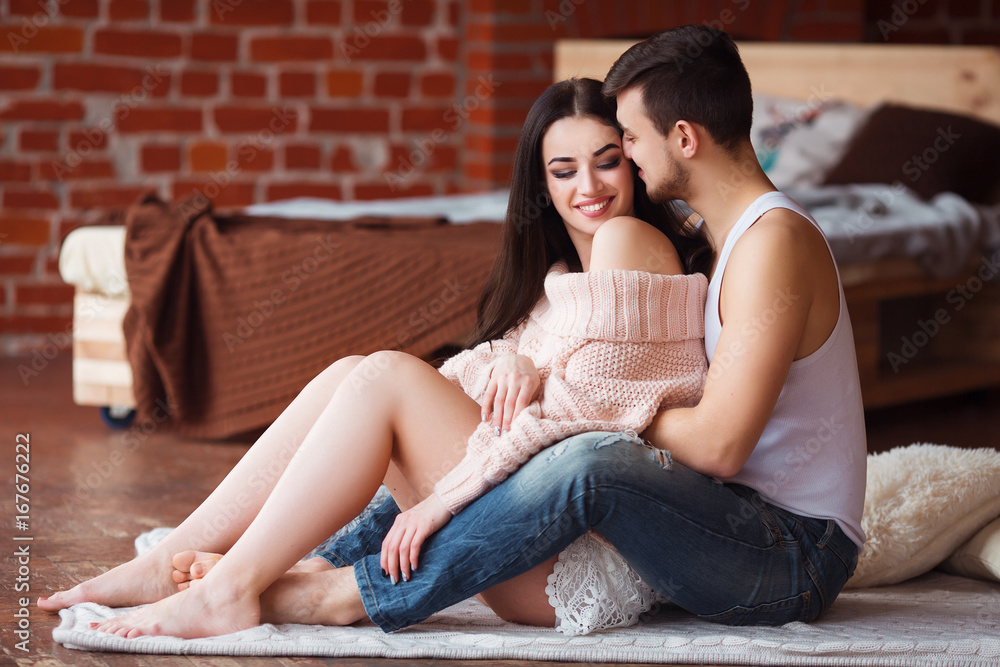 Romantic couple. Passion time. Young loving couple embracing and looking to each other at home. Romantic couple. Passion time. Young loving couple embracing and looking to each other at home.