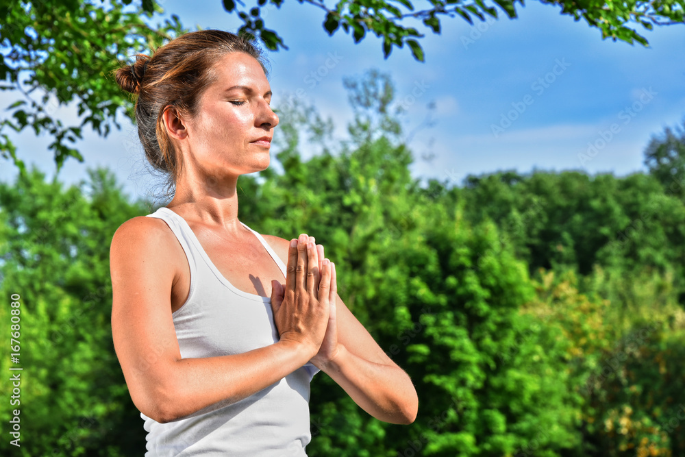 Young woman during yoga meditation in the park Young woman during yoga meditation in the park