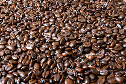 Macro shot of coffee beans on top of a white surface