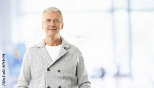 Cropped shot of a happy senior businessman standing at the office. 