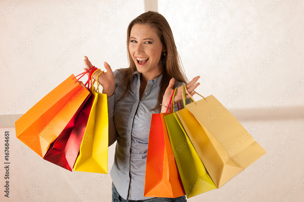 attractive young woman wtih shopping bags after purchasing in mall attractive young woman wtih shopping bags after purchasing in mall