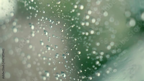 Raindrops rain droplets on glass window macro shot natural background