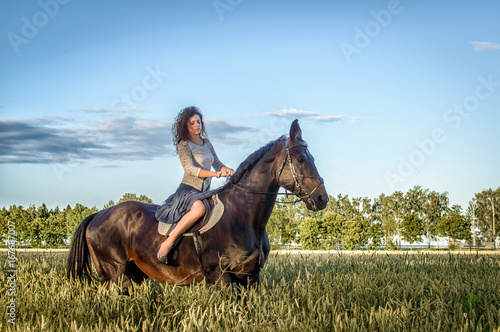 the young girl on a horse in the field