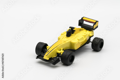 Yellow toy as formula car isolated on white