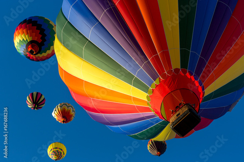 Festival of Ballooning. Colorful hot air balloon flying in the bright blue sky.