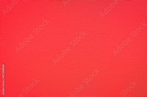 Textured red plastic surface close up