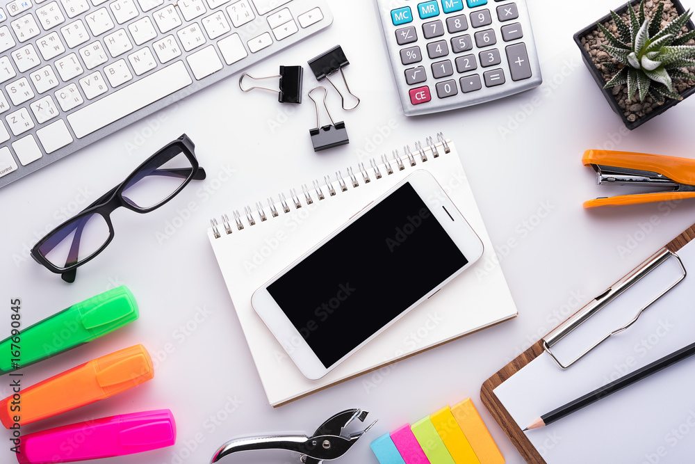 White office desk table with school accessories with office supplies. Top view with copy space White office desk table with school accessories with office supplies. Top view with copy space