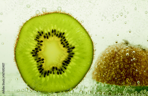 Kiwi in water with bubbles.