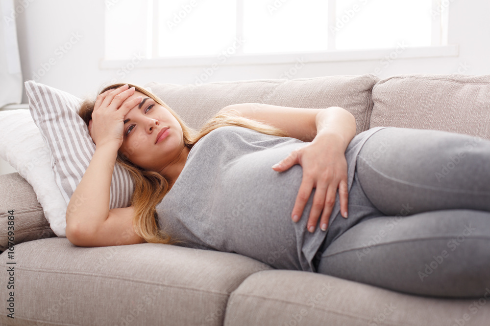Young expectant blonde with headache copy space Young expectant blonde with headache copy space