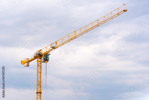 big yellow crane on a blue cloudy sky