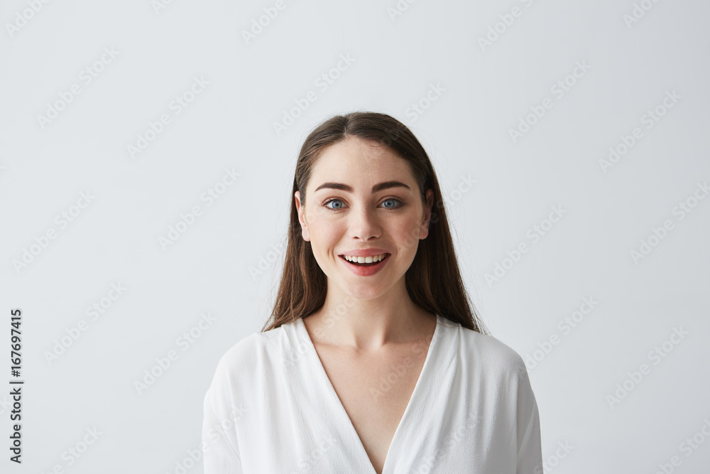 Portrait of surprised happy young beautiful businesswoman looking at camera over white background. Portrait of surprised happy young beautiful businesswoman looking at camera over white background.