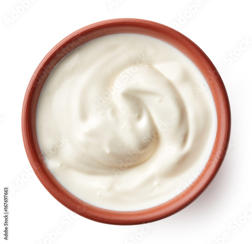 Cream in clay bowl isolated on white, from above