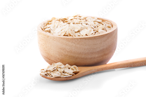Oat flakes in bowl and wooden spoon isolated on white background.with clipping path