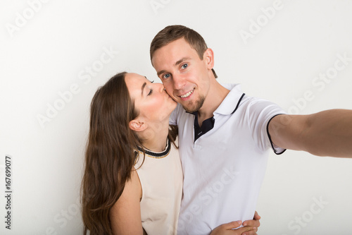 Young loving couple taking selfie on camera