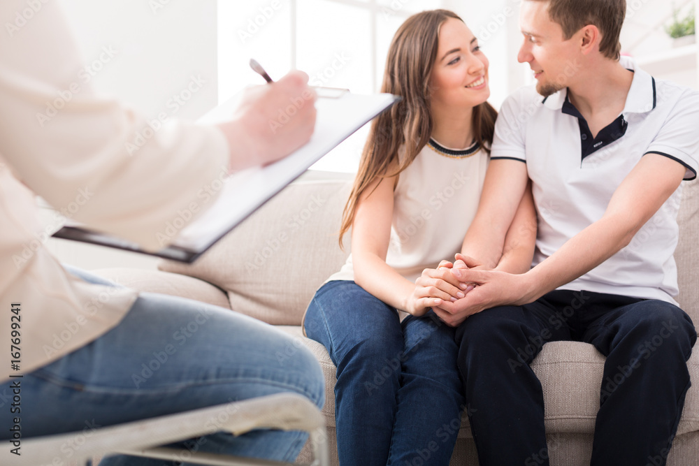Happy couple reconciling at therapy session Happy couple reconciling at therapy session