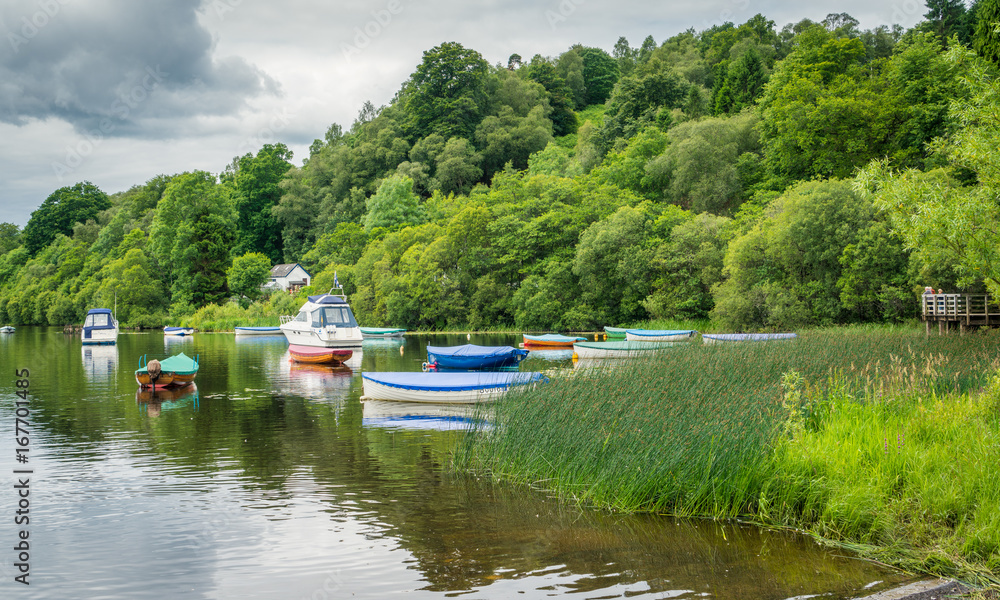 Docked boats in Balmaha, Loch Lomond,  in the council area of Stirling, Scotland.