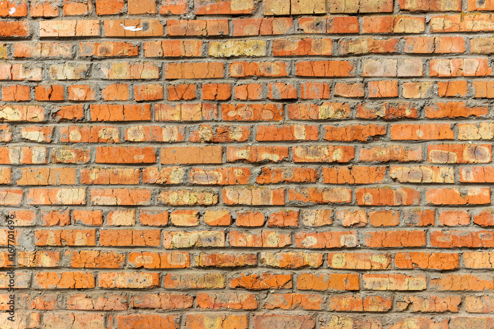 Fototapeta premium Background of old vintage dirty brick wall with peeling plaster, texture