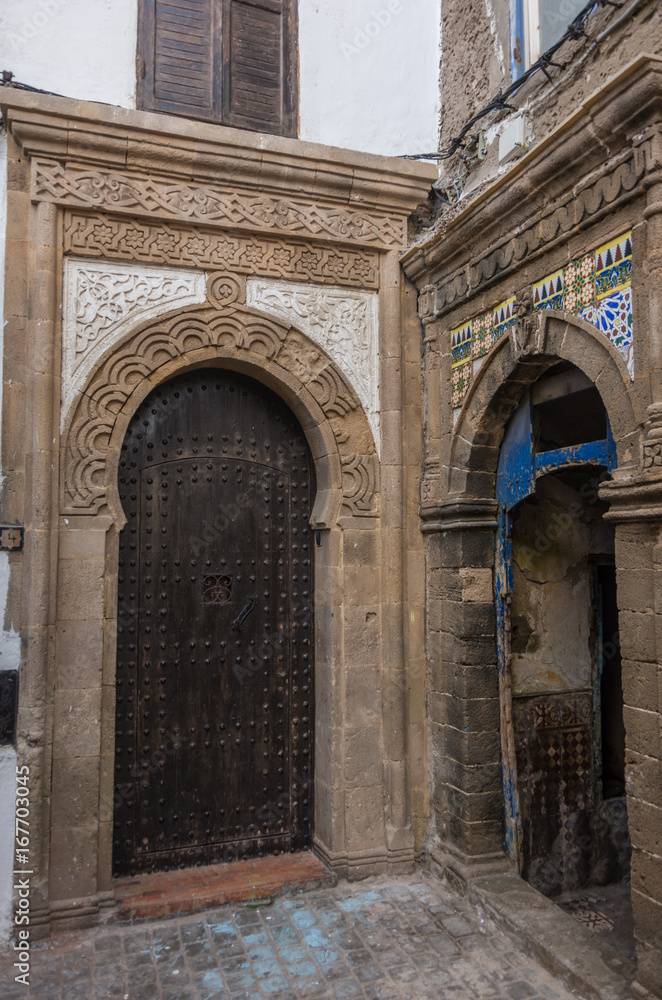 Narrow street, old doors and colorful old houses of medieval medina of Essaouira, Morocco