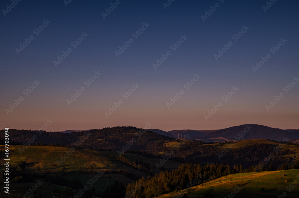 Fototapeta premium Background with Ukrainian Carpathian Mountains during the sunset in the Pylypets