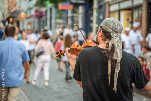 street musician playing violin or viola in streets of old Quebec City photo