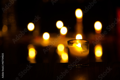 candle flames glowing in the dark.