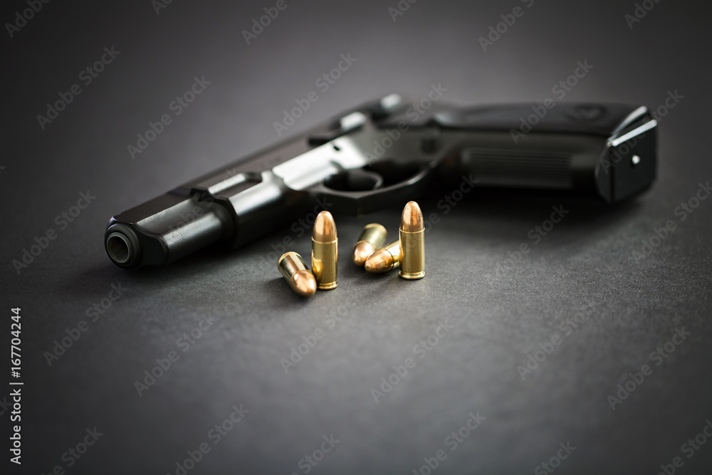 Handgun with ammunition on black background Handgun with ammunition on black background