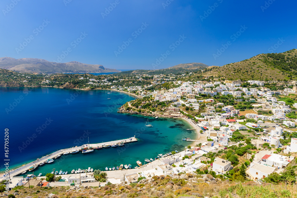 The picturesque Greek Islands. Aerial view of the coastline and the Panteli village, a traditional Greek village with white buildings and fishing boats, Leros island, Greece