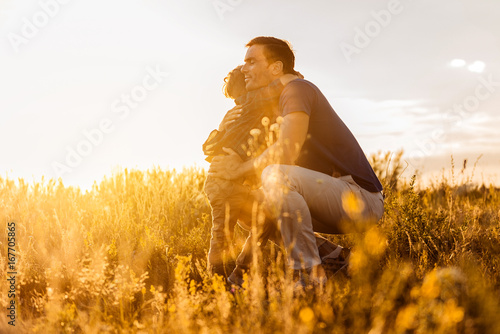 Lovely family embracing on meadow
