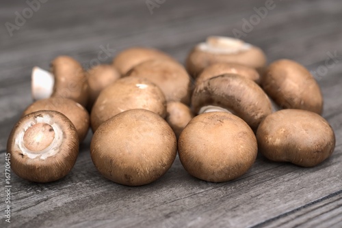 Fresh brown mushrooms on a wooden background. photo