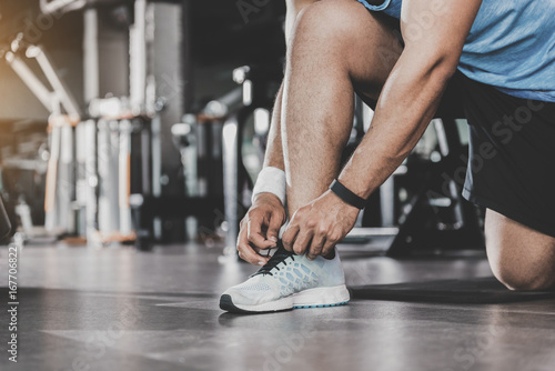 Man arms tying shoelaces in keep-fit studio