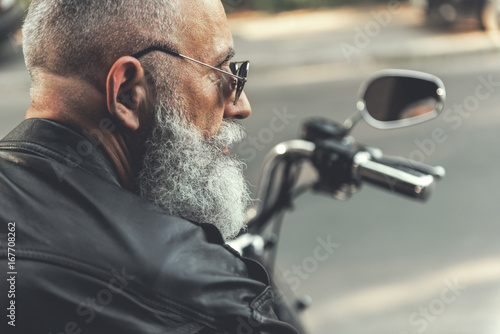 Old male person on motorbike