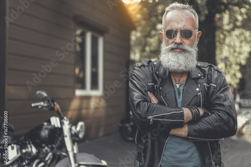 Assured elder man locating near motorcycle © Yakobchuk Olena