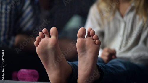 Close up of a little girls feet resting on the sofa photo