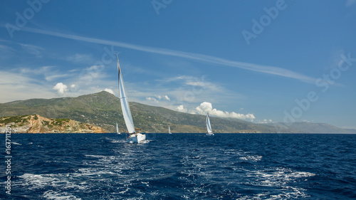 Luxury yachts Regatta at Sea. Sailing through the waves.